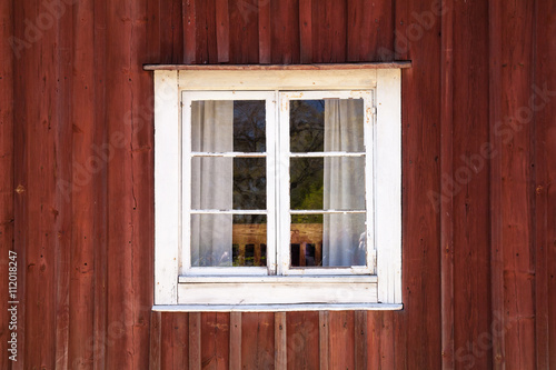 Old wooden wall with window in white frame