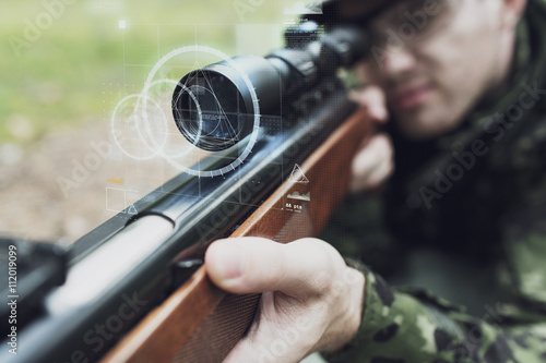 Obraz na plátně close up of soldier or sniper with gun in forest