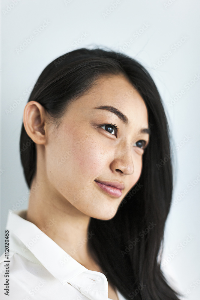 Close up of young woman against white background Close up of young woman against white background