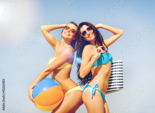girls with ball on the beach
