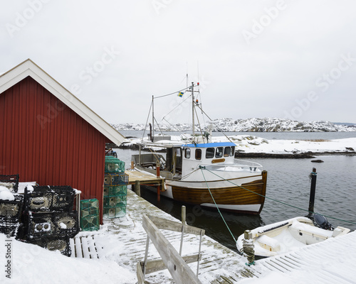 Fishing boat moored at jetty photo