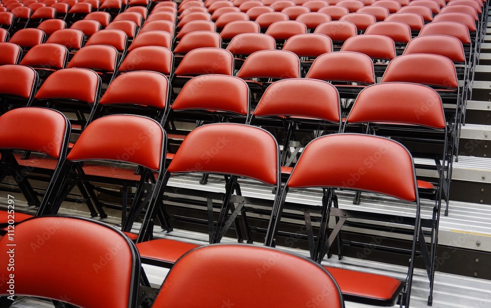 Fototapeta premium Folded red seats at a multipurpose arena and sports stadium