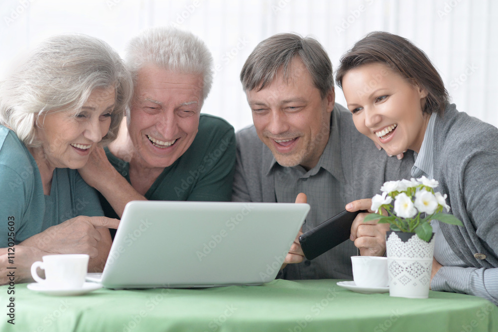Happy smiling family with laptop Happy smiling family with laptop