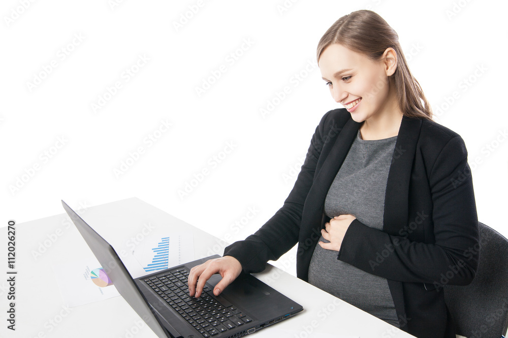 Happy pregnant woman at desktop with laptop Happy pregnant woman at desktop with laptop