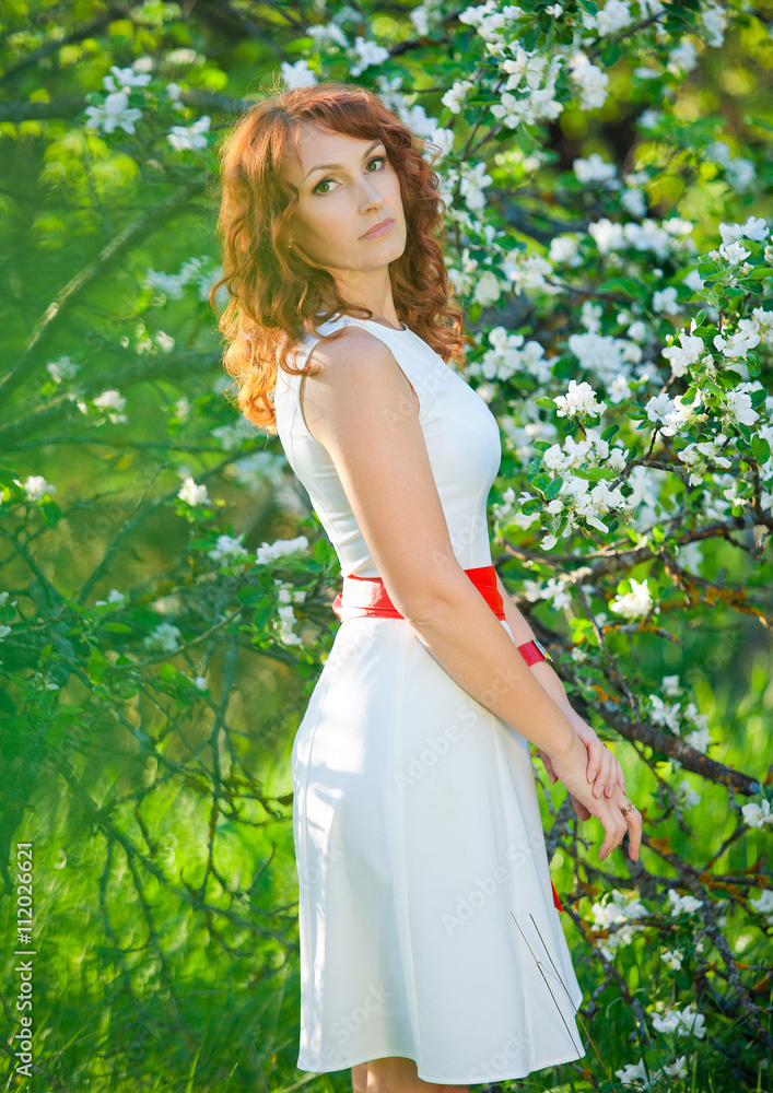 Romantic young woman in the spring garden among apple blossom. Romantic young woman in the spring garden among apple blossom.