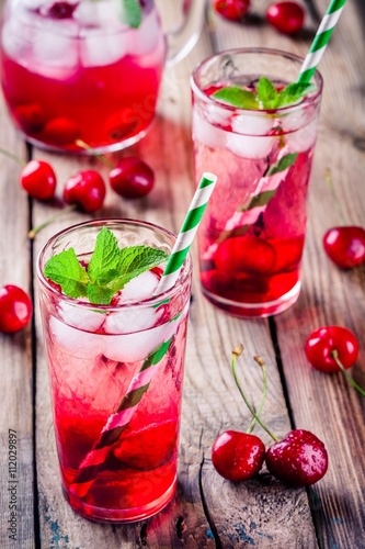 cherry lemonade with ice and mint in glasses