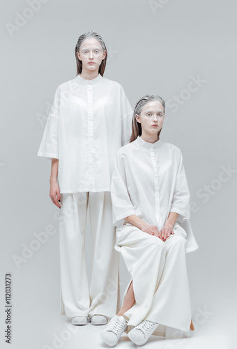 Two beautiful mystical women in white dress