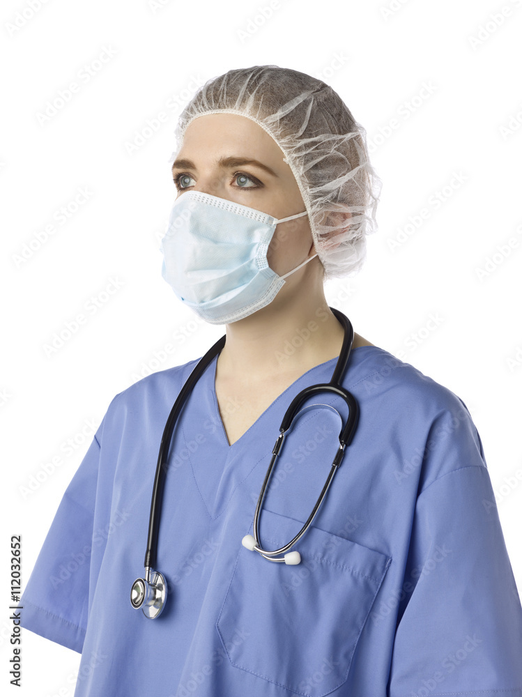 female nurse wearing face mask while looking at something female nurse wearing face mask while looking at something