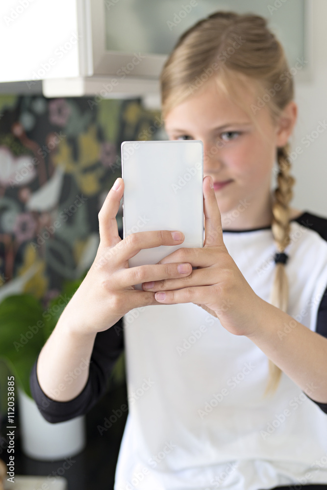 Girl taking picture of herself with smartphone Girl taking picture of herself with smartphone