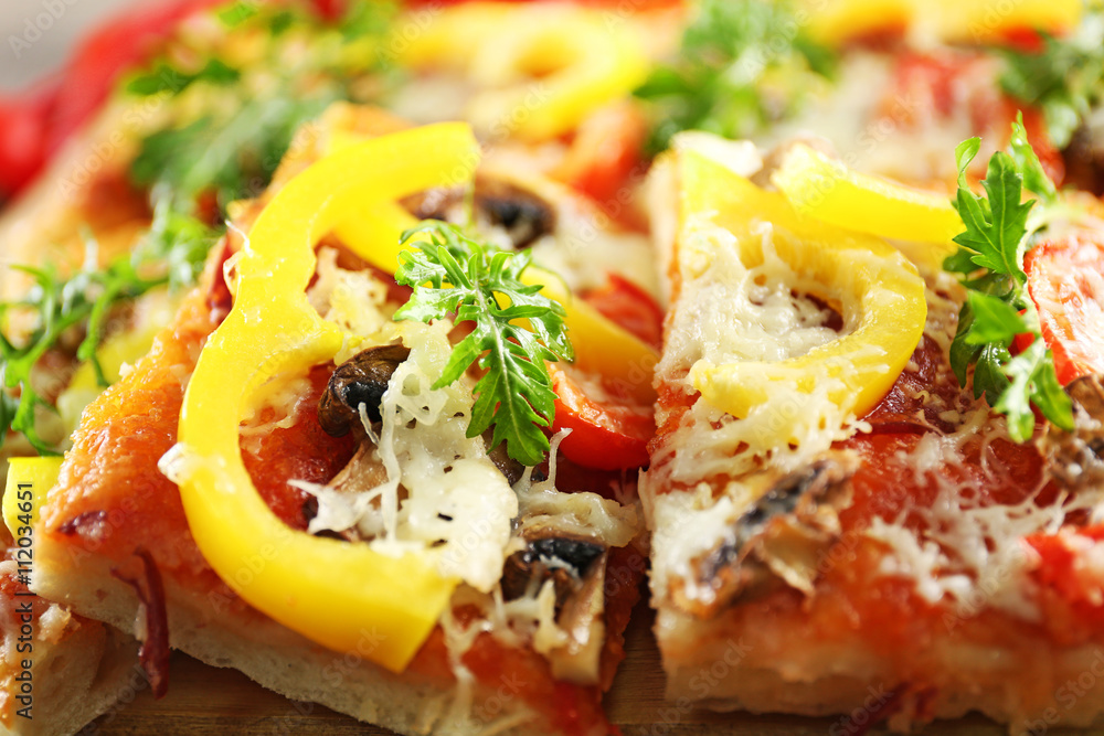 Pieces of delicious pizza on the table, close-up Pieces of delicious pizza on the table, close-up
