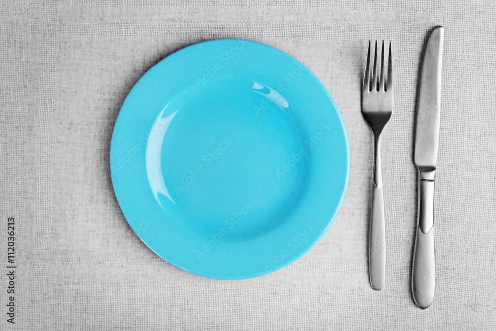 Empty plate with silver cutlery on wooden background Empty plate with silver cutlery on wooden background