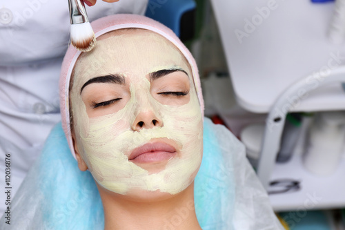 Young woman having face pro...