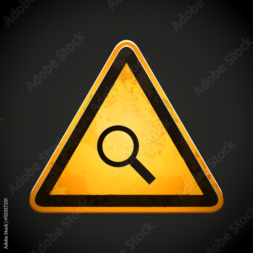 danger sign with a magnifying glass
