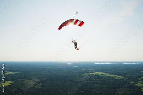 Rear view of man parachuting in air
