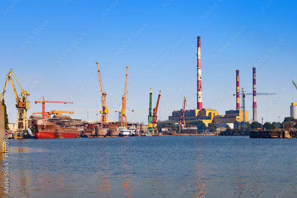 View wharf shipyard with high chimneys in the background in Gdansk, Poland.