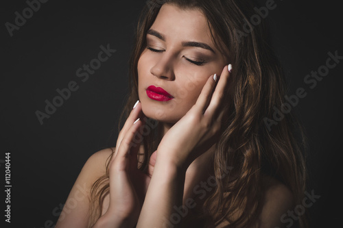Tender brunette woman with closed eyes