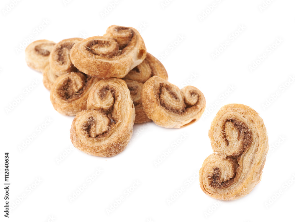 Single cookie next to Pile of cookies isolated over the white background