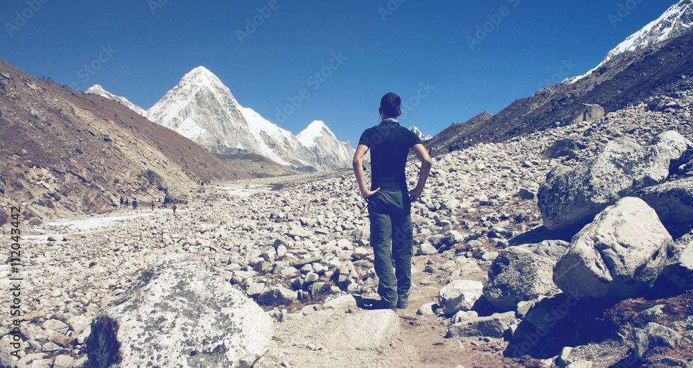 Man standing surveying a glacier in Nepal