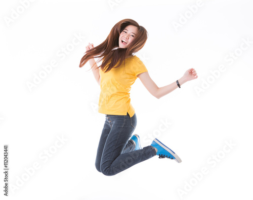 Jumping female college / university student isolated on white ba