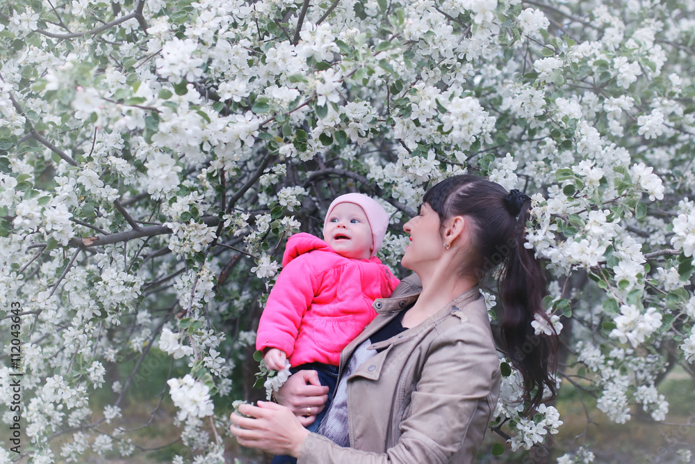 mother with baby in apple garden