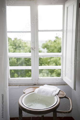 Washstand in a front of a window in a country house