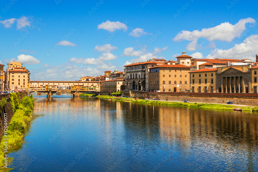 Florence, Ponte Vecchio bridge over river Arno and Palazzo Vecchio (Tuscany, Italy)