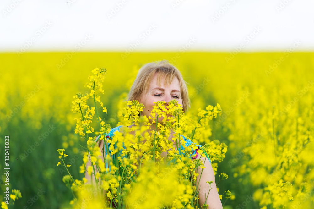 The woman smells aromas of spring flowers. The woman smells aromas of spring flowers.