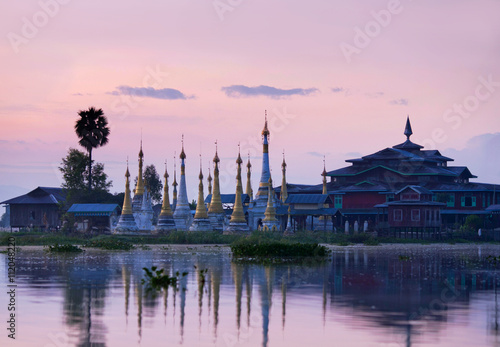 Ancient pagoda and monastery at sunrise on Inle lake, Myanmar © Zzvet