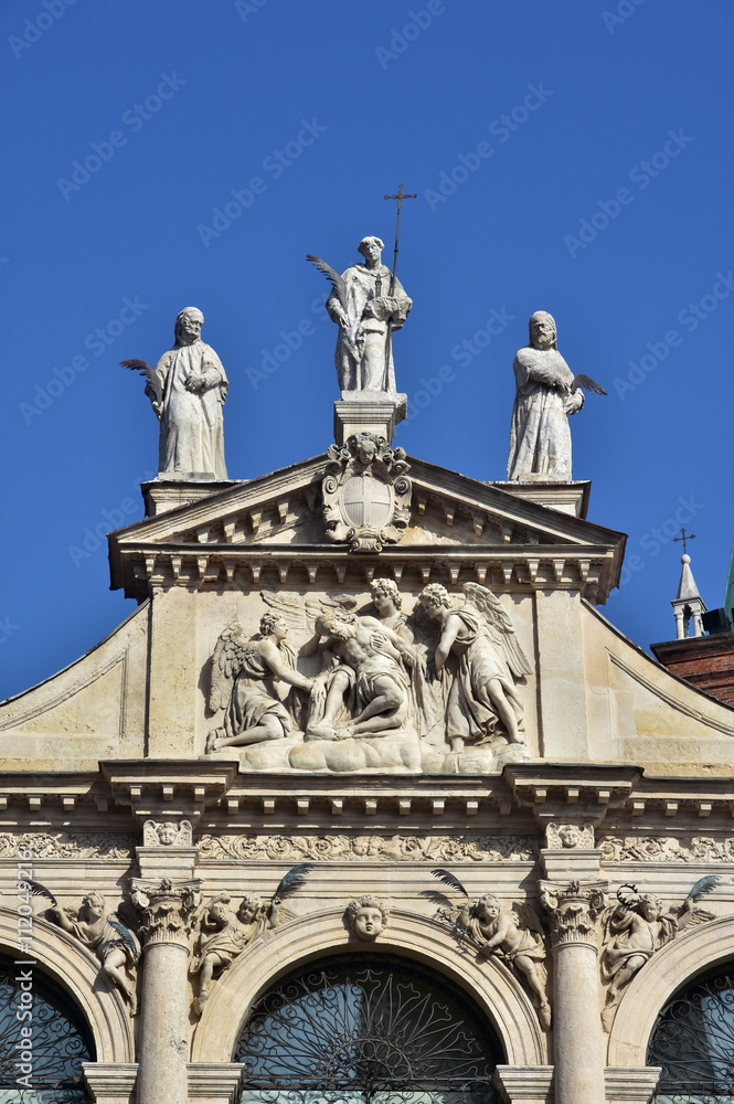 Detail of the beautiful St Vincent baroque church in the center of Vicenza, with statue of Jesus, angels and saints (17th century)