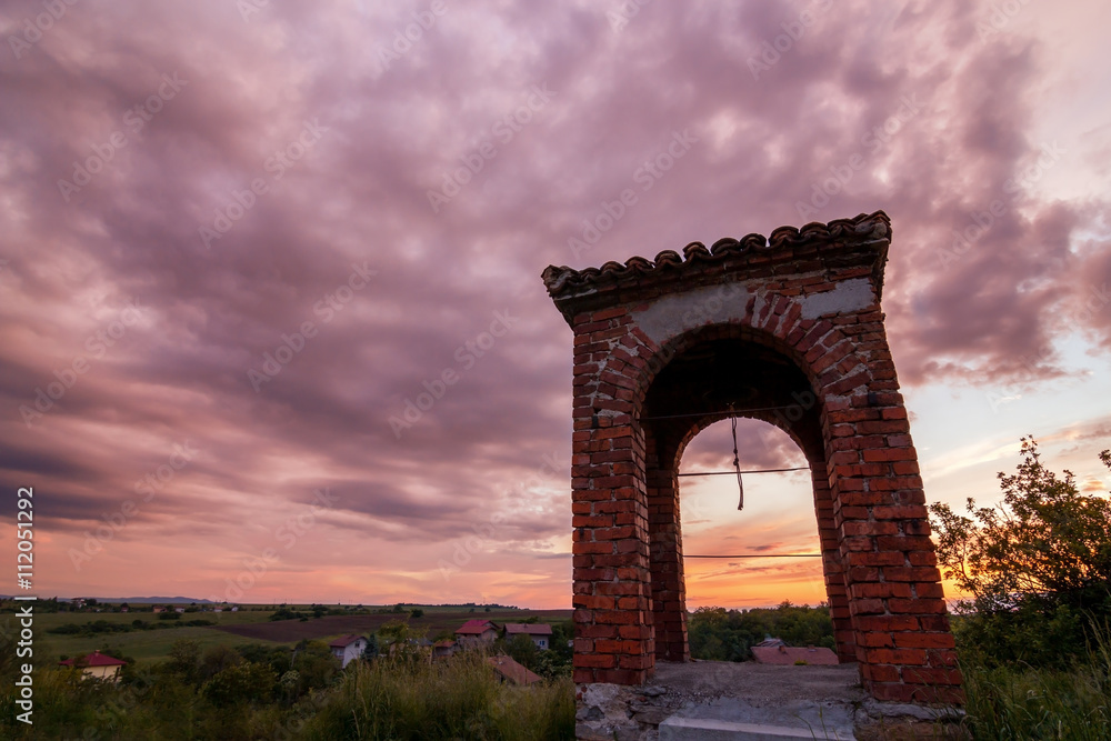 old bell tower at sunset