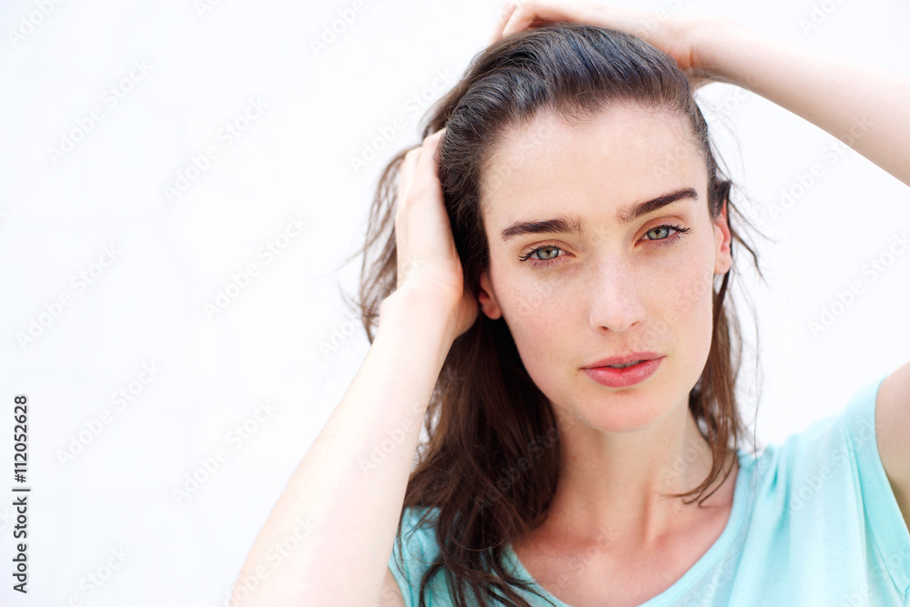 Young attractive woman with hands through hair Young attractive woman with hands through hair