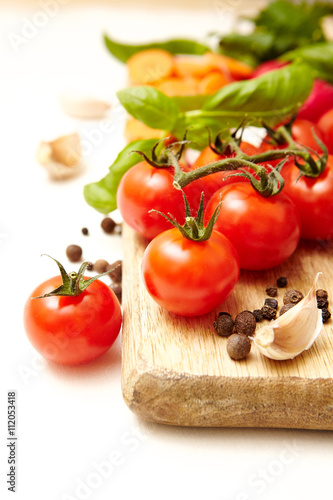 Fresh organic ingredients on white background Tomatoe, garlic, pepper,carrots, radishes