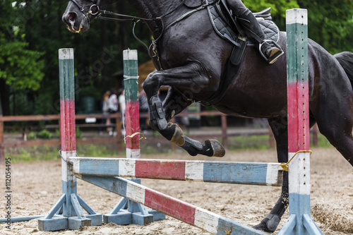 sportsman on horse overcomes barrier