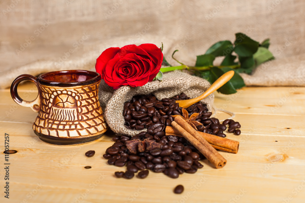 cup of coffee and coffee beans with a red rose cup of coffee and coffee beans with a red rose