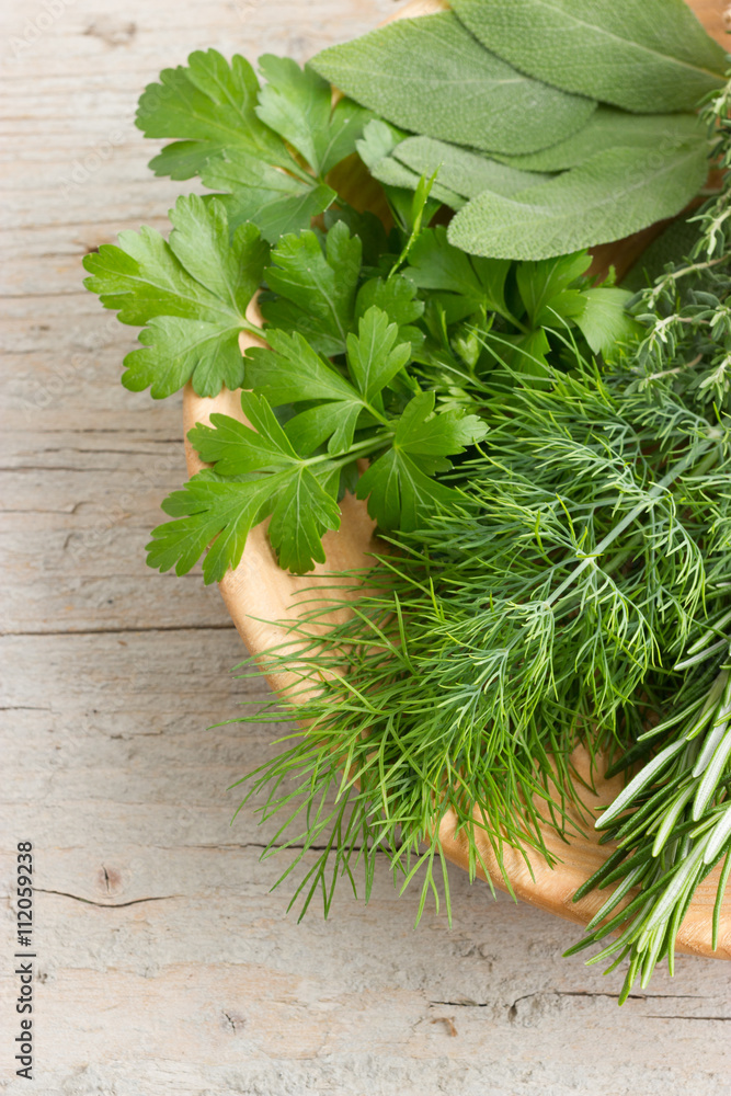 Freshly harvested herbs on wooden rustic background. Top view Freshly harvested herbs on wooden rustic background. Top view