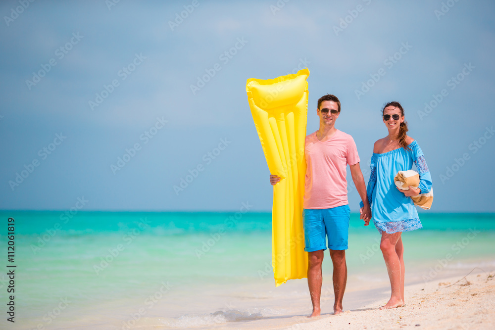 Young family on white beach at summer vacation Young family on white beach at summer vacation