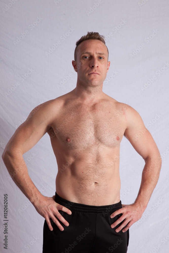 Fototapeta premium Shirtless man with his hands on his hips