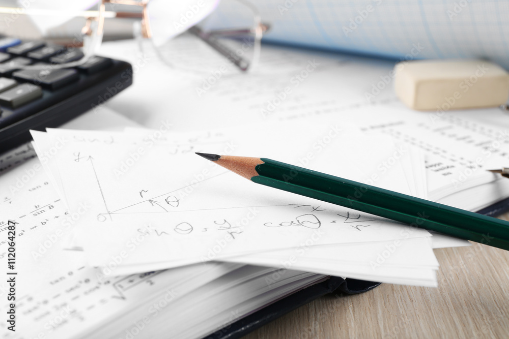 School supplies and textbook on mathematics close up School supplies and textbook on mathematics close up
