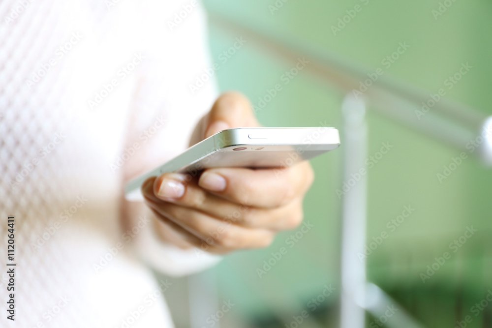 Woman holding smartphone indoors