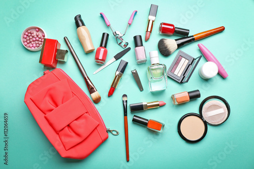 Decorative makeup cosmetics and manicure tools on turquoise background