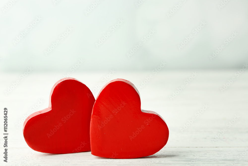 Fototapeta premium Wooden hearts on light background
