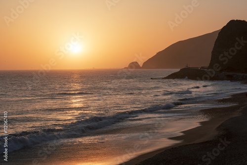 The Pacific ocean during sunset. Landscape with blue sea, the mountains and the dusk sky, the USA, Santa Monica. 