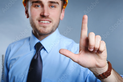 Male pointing finger on gre...