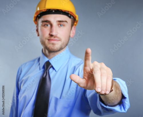 Male pointing finger on gre...