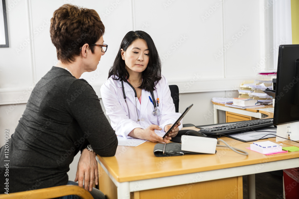Doctor Showing Digital Tablet To Patient Doctor Showing Digital Tablet To Patient