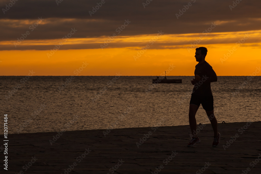 Athlete jogging next to the sea