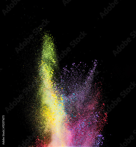 Explosion of colored powder on black background