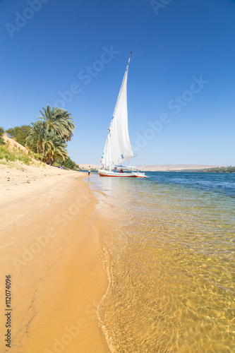 Felucca  traditional wooden sailboat on shore of Nile  Egypt.