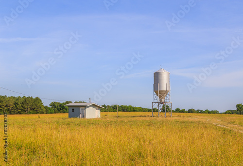 Missile Shaped Silo and Keep Shack:
Small missile or bomb shaped grain silo and powered keep shack in an open field in Demopolis, Alabama. photo