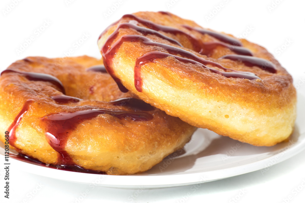 Unhealthy fat donuts with a berry jam